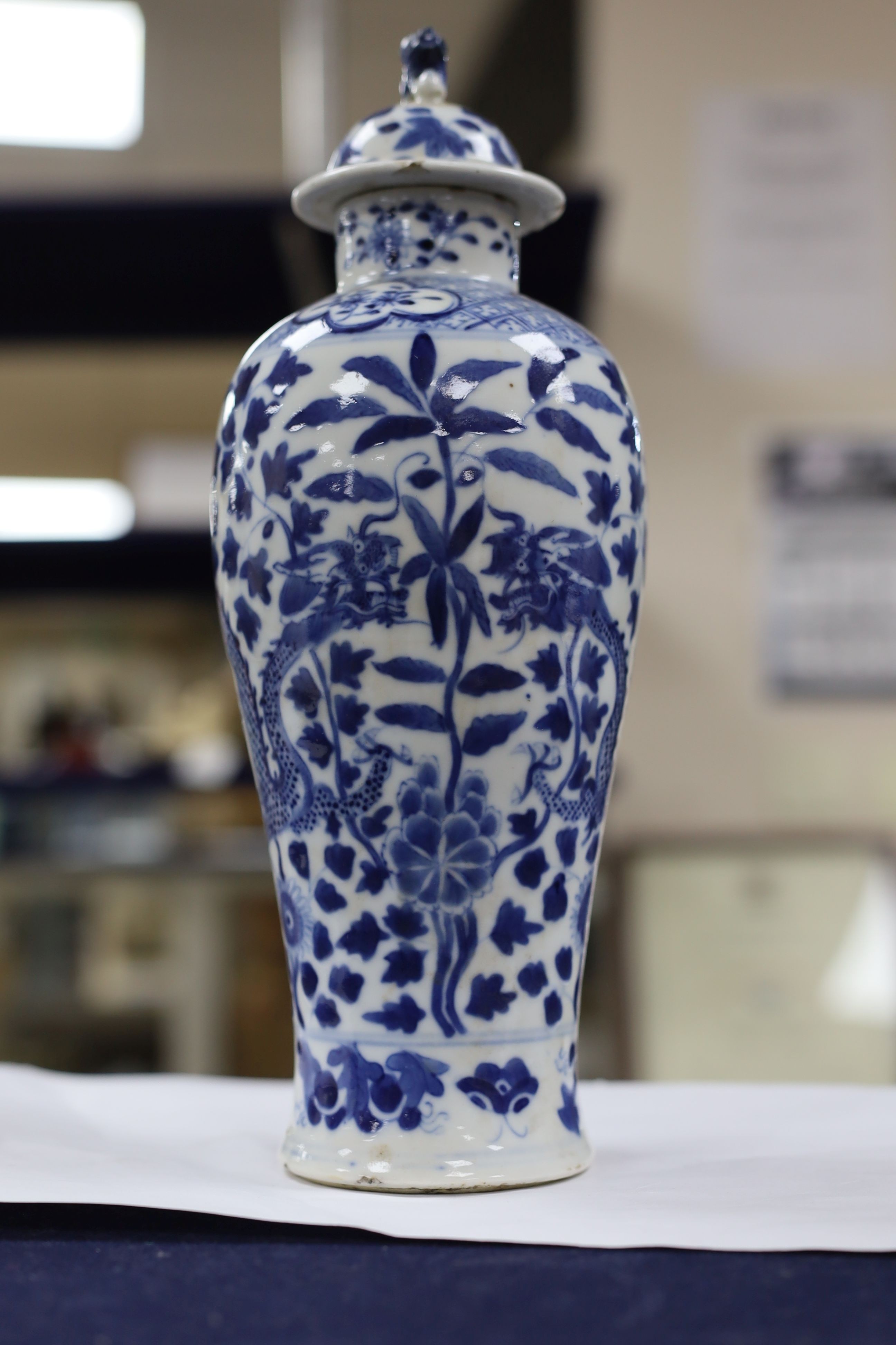 A pair of Chinese blue and white dragon vases and covers, circa 1900. 28cm